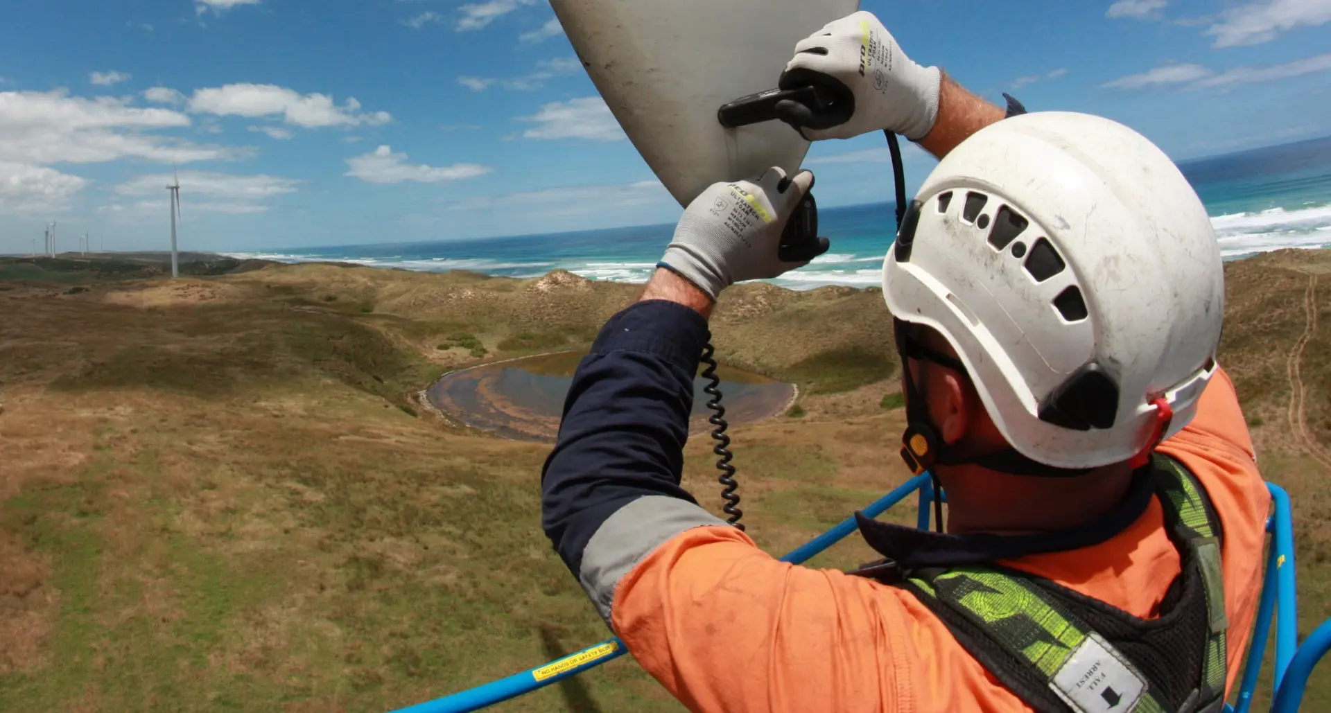 SPIE technician working at height on a coastal wind turbine