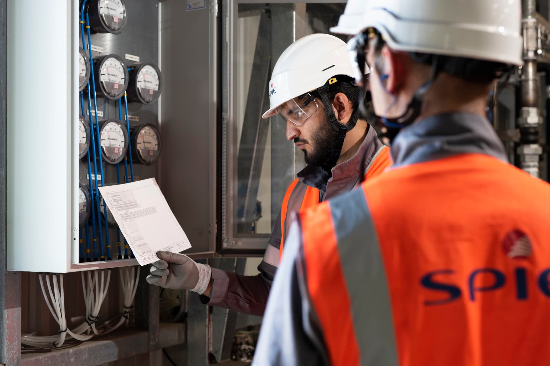 SPIE technicians reviewing readings at an instrumentation panel
