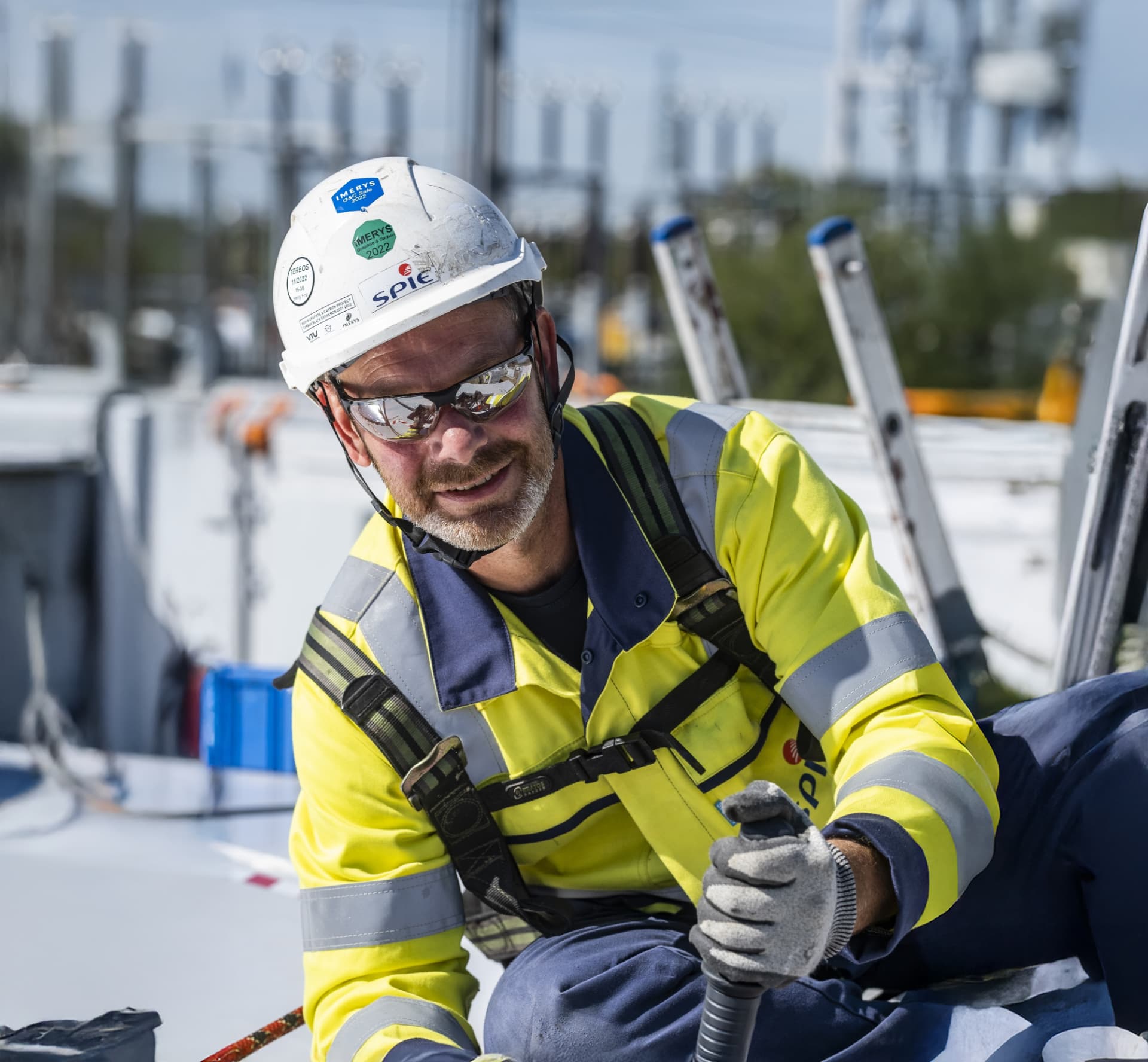 SPIE technician in high-vis workwear working on site equipment